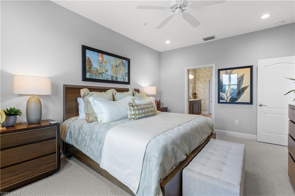2311 Sawyers Hill Road, Unit 805 Naples, FL 34120 - Photo 19 of 27 a bedroom with bed and a chandelier