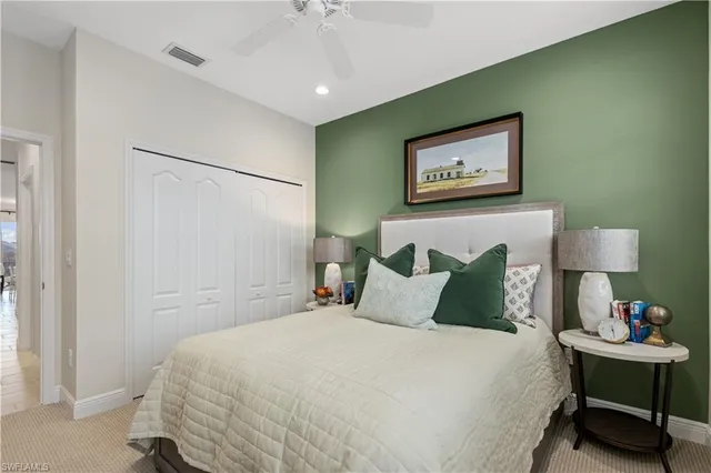 a bedroom with a bed and a lamp on table