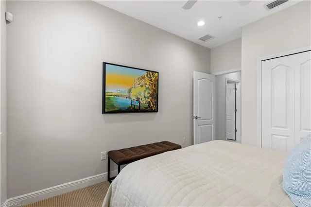 a bedroom with a bed and a wall painting