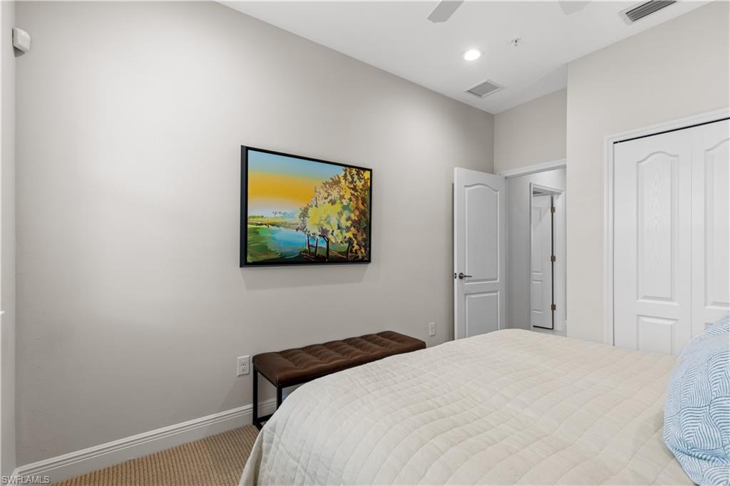 2311 Sawyers Hill Road, Unit 805 Naples, FL 34120 - Photo 23 of 27 a bedroom with a bed and a wall painting