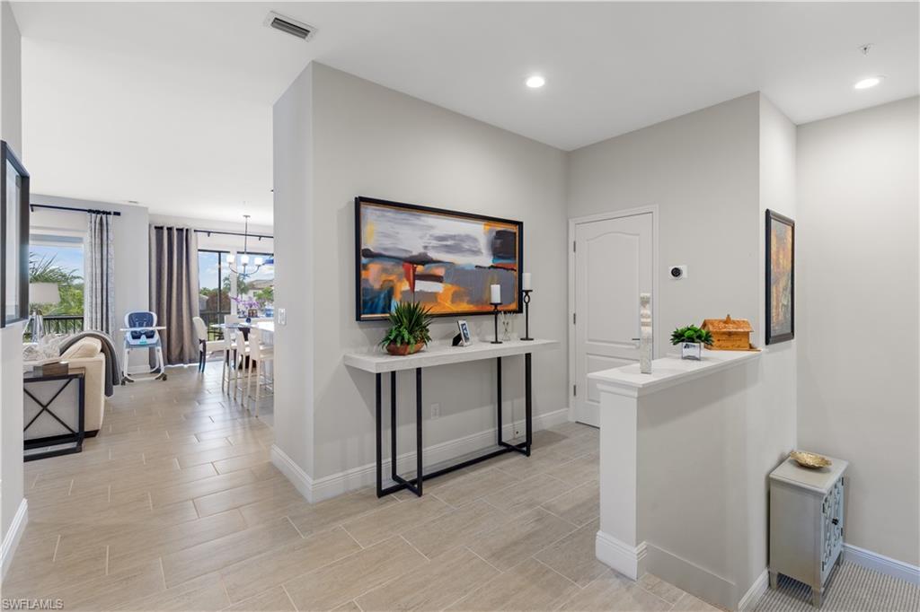 2311 Sawyers Hill Road, Unit 805 Naples, FL 34120 - Photo 24 of 27 a living room with furniture and a flat screen tv