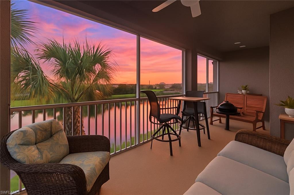 2311 Sawyers Hill Road, Unit 805 Naples, FL 34120 - Photo 6 of 27 a living room with furniture a floor to ceiling window and potted plants