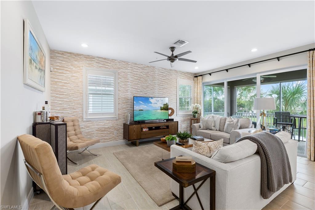 2311 Sawyers Hill Road, Unit 805 Naples, FL 34120 - Photo 8 of 27 a living room with furniture and a flat screen tv