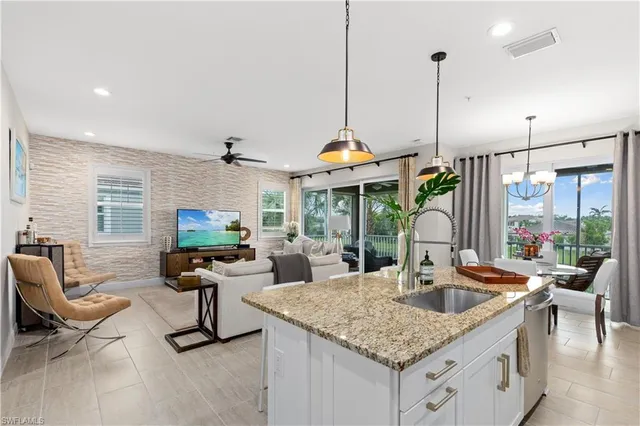 a kitchen with a counter space a sink and chandelier