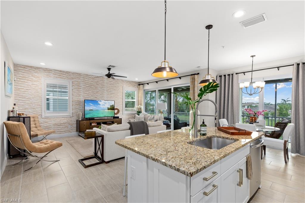 2311 Sawyers Hill Road, Unit 805 Naples, FL 34120 - Photo 9 of 27 a kitchen with a counter space a sink and chandelier