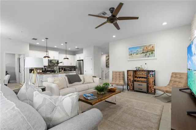 a living room with furniture and kitchen view