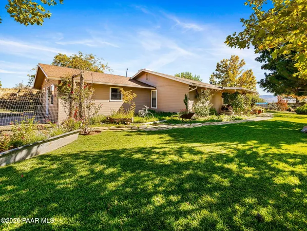 an aerial view of a houses with a yard