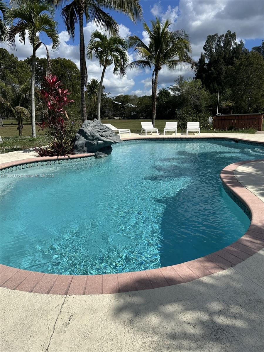 18901 Southwest 53rd Street Southwest Ranches, FL 33332 - Photo 23 of 24 a view of a swimming pool with a yard