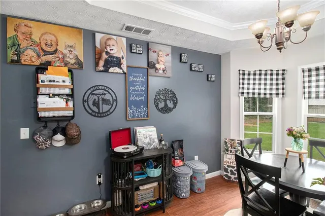 a view of a dining room with furniture a kitchen and a window