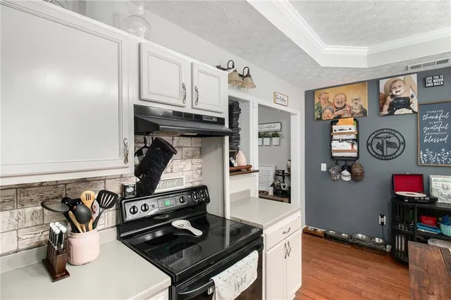 a kitchen with stainless steel appliances granite countertop a stove and a refrigerator
