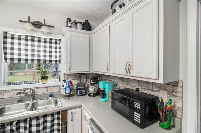a kitchen with a refrigerator and a sink