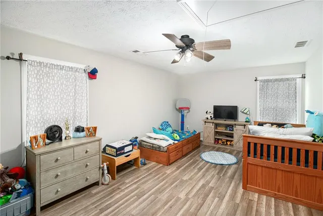 a bedroom with furniture and a baby crib