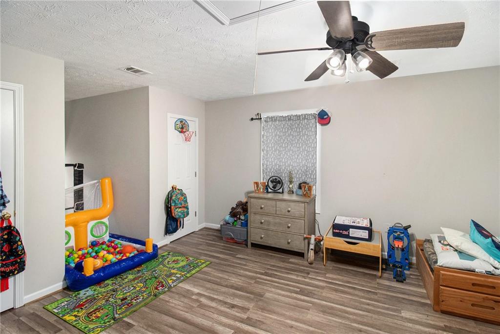 23 Erskine Road Monticello, GA 31064 - Photo 23 of 38 a bedroom with furniture and a baby crib