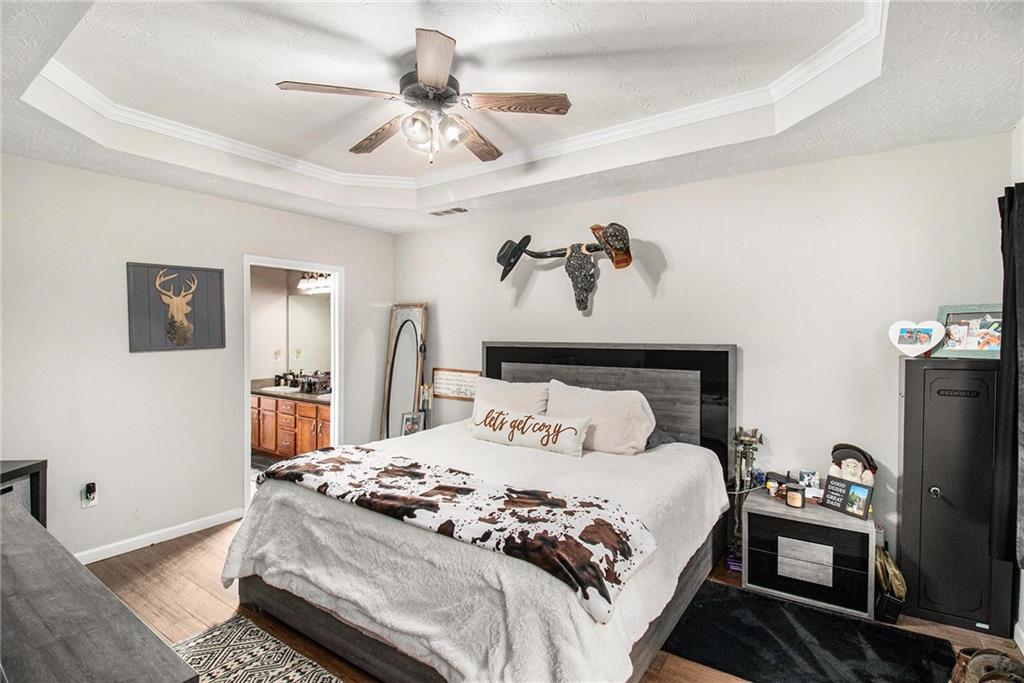 23 Erskine Road Monticello, GA 31064 - Photo 24 of 38 a bedroom with a large bed and a chandelier