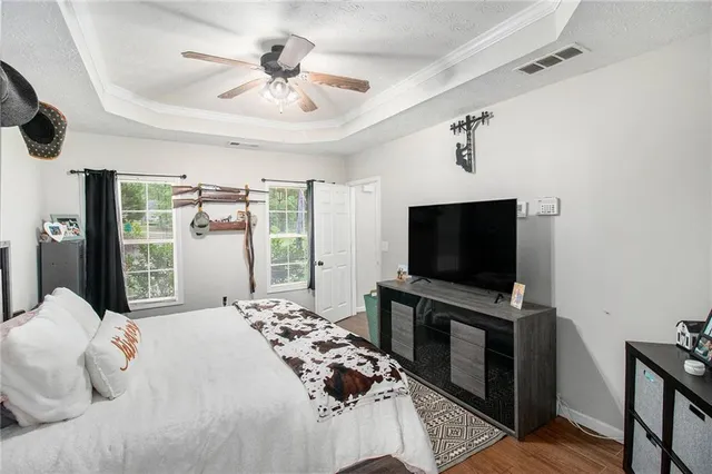 a bedroom with furniture and a flat screen tv