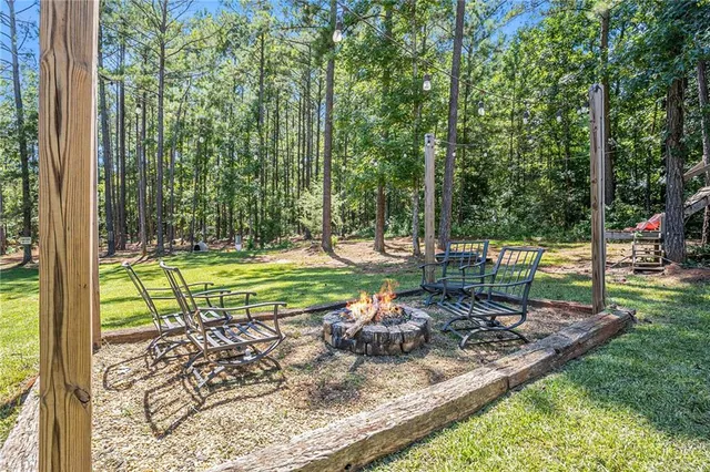 a front view of a house with a yard table and chairs