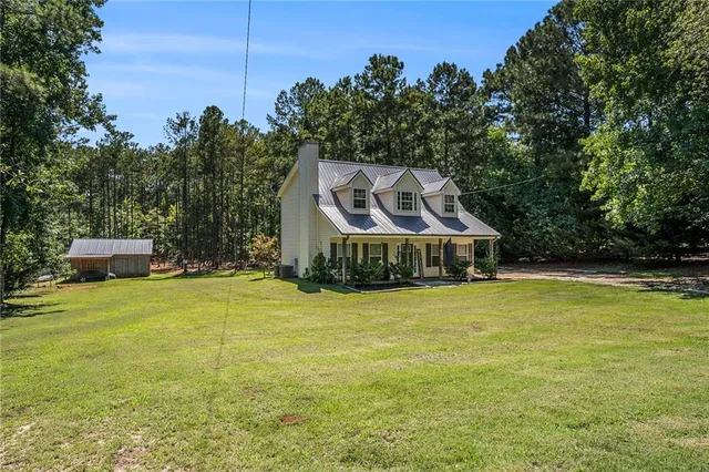 a backyard of a house with table and chairs