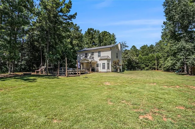 an aerial view of a house with a yard