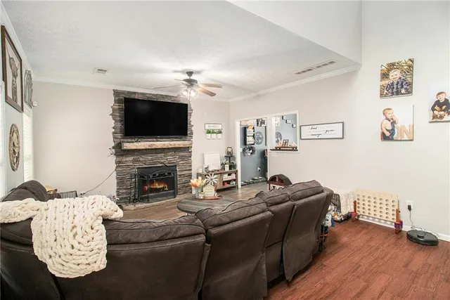 a living room with furniture a flat screen tv and a fireplace