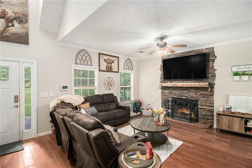 23 Erskine Road Monticello, GA 31064 - Photo 5 of 38 a living room with furniture a fireplace and a flat screen tv