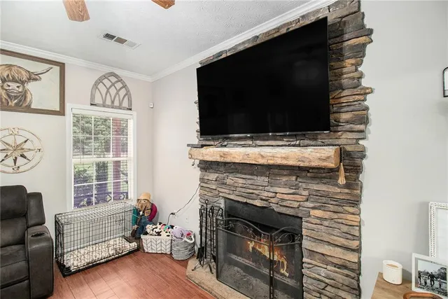 a living room with furniture a flat screen tv and a fireplace