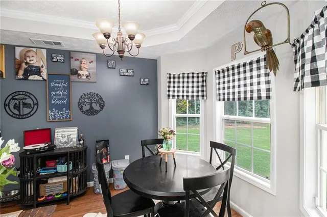 a view of a dining room with furniture and chandelier