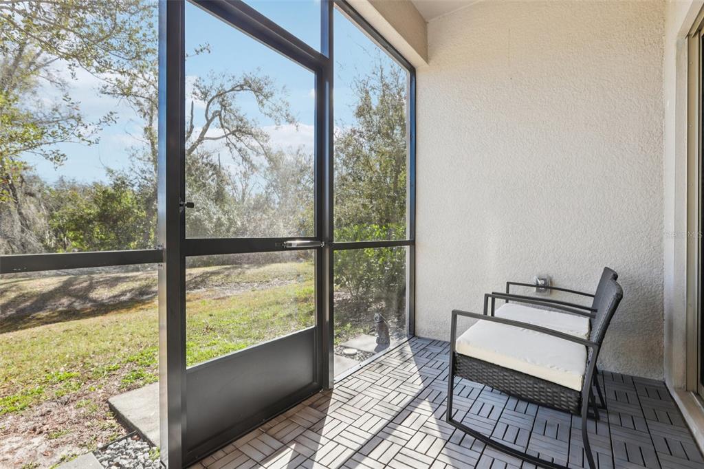 1306 White Fox Run Lutz, FL 33549 - Photo 28 of 35 a view of a room with wooden floor and a floor to ceiling window