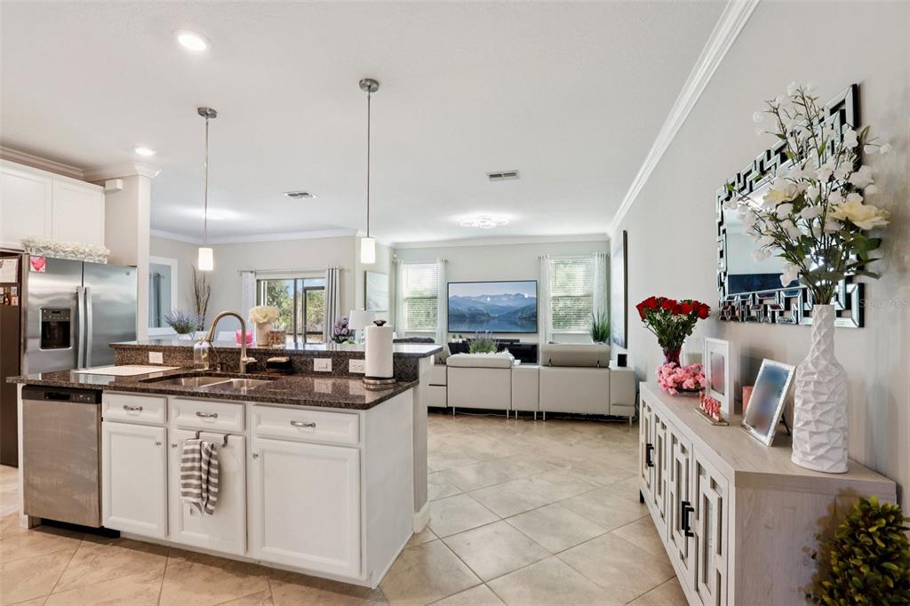 1306 White Fox Run Lutz, FL 33549 - Photo 7 of 35 a kitchen that has a lot of cabinets in it and wooden floors