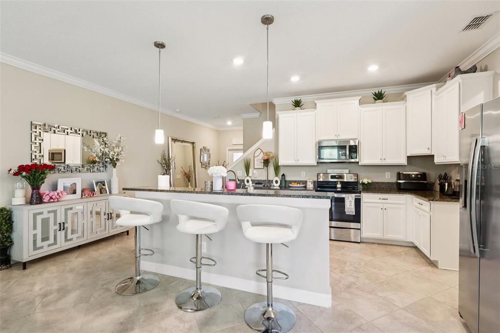 1306 White Fox Run Lutz, FL 33549 - Photo 10 of 35 a kitchen with stainless steel appliances kitchen island granite countertop lots of counter top space