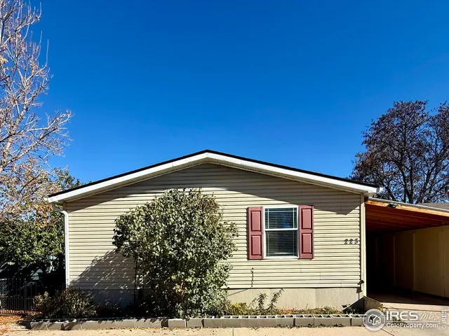 a front view of a house with plants