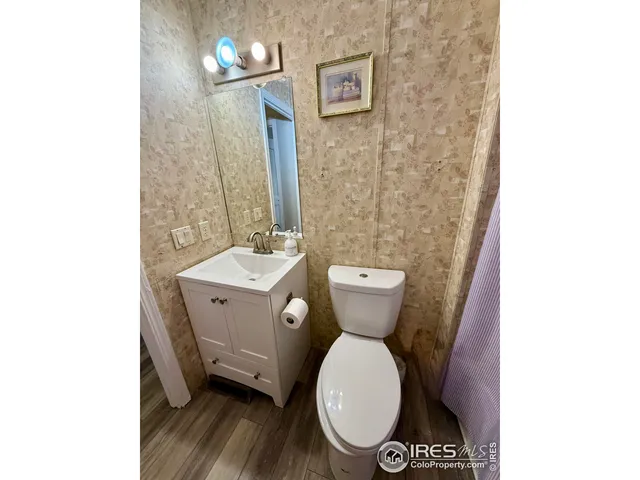a kitchen with granite countertop white cabinets and black appliances