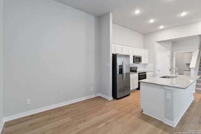 a kitchen with stainless steel appliances a refrigerator and a sink