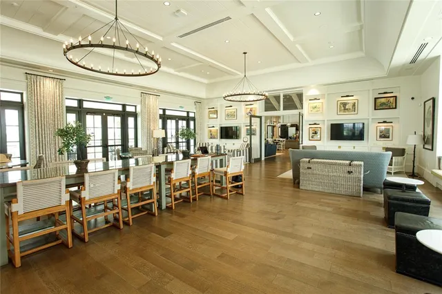 a living room with furniture a table and kitchen view