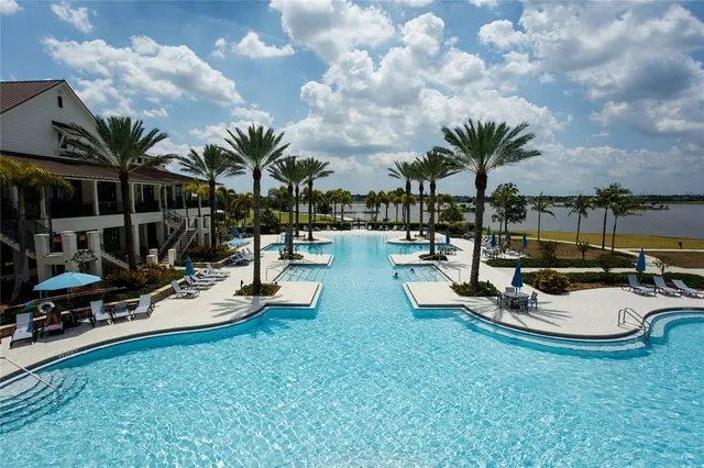 a view of a swimming pool with lounge chairs