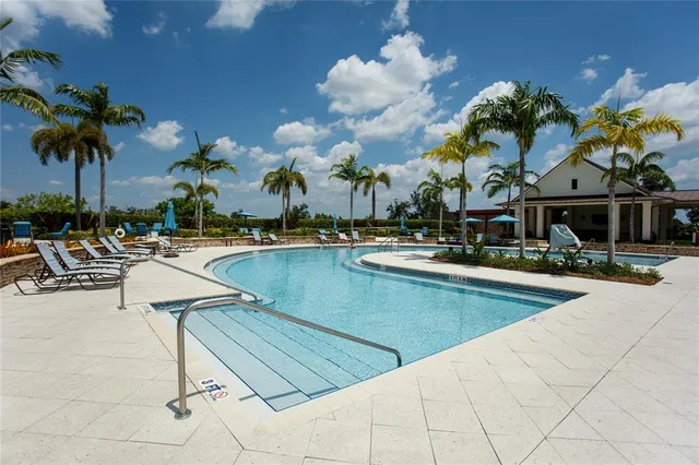 a view of a swimming pool with outdoor seating
