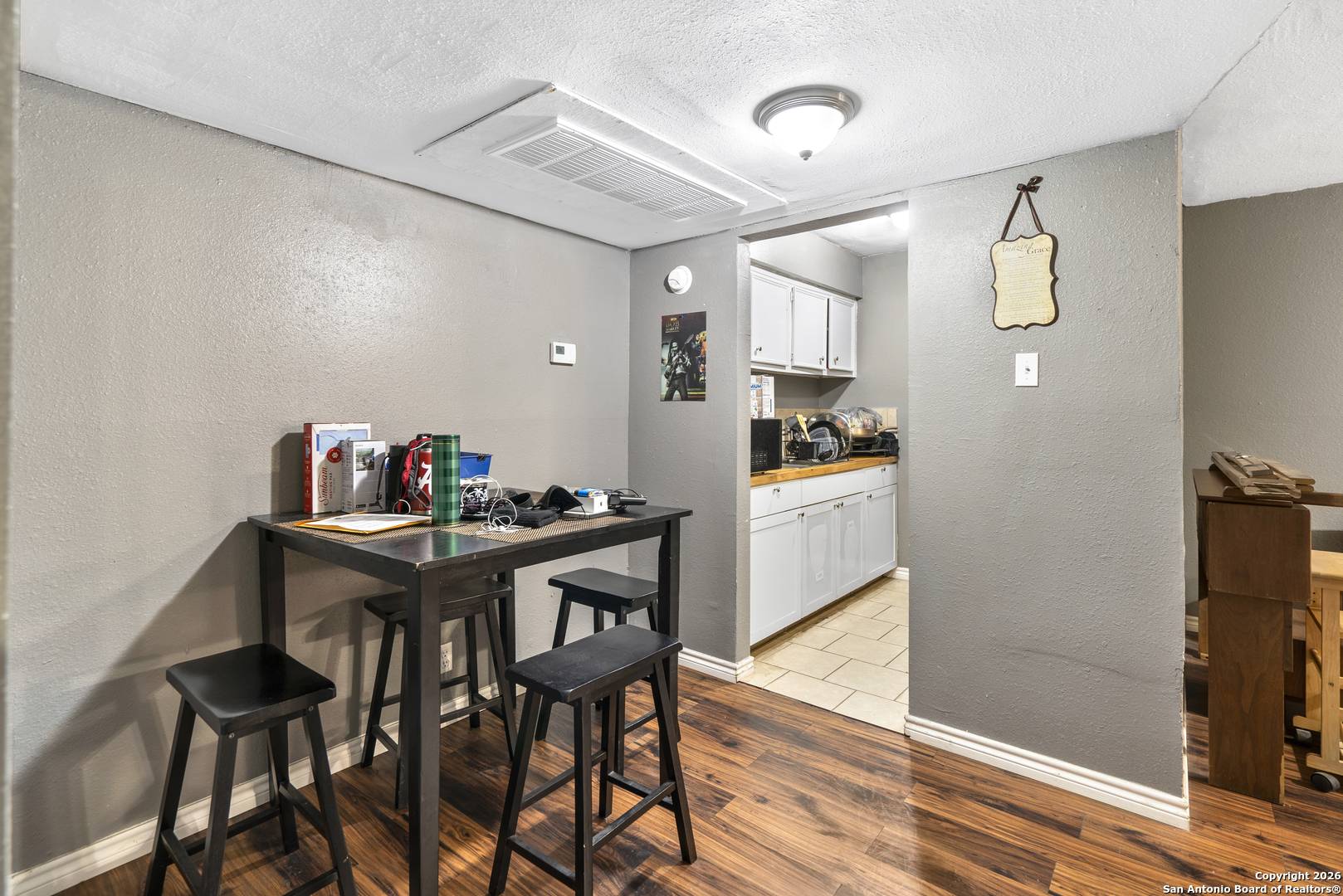 3122 Culebra Road, Unit 104 San Antonio, TX 78228 - Photo 3 of 14 a view of a dining room with furniture and wooden floor
