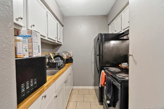 a kitchen with stainless steel appliances granite countertop a refrigerator and a stove