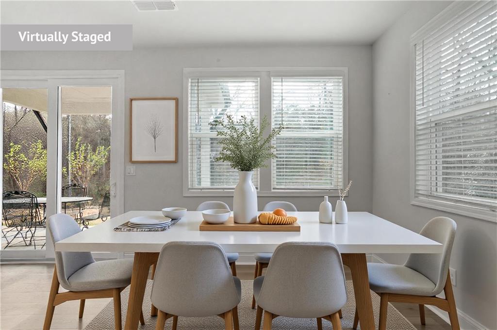 764 Clifftop Crossing Southwest Powder Springs, GA 30127 - Photo 12 of 38 a dining room with table chairs and wooden floor