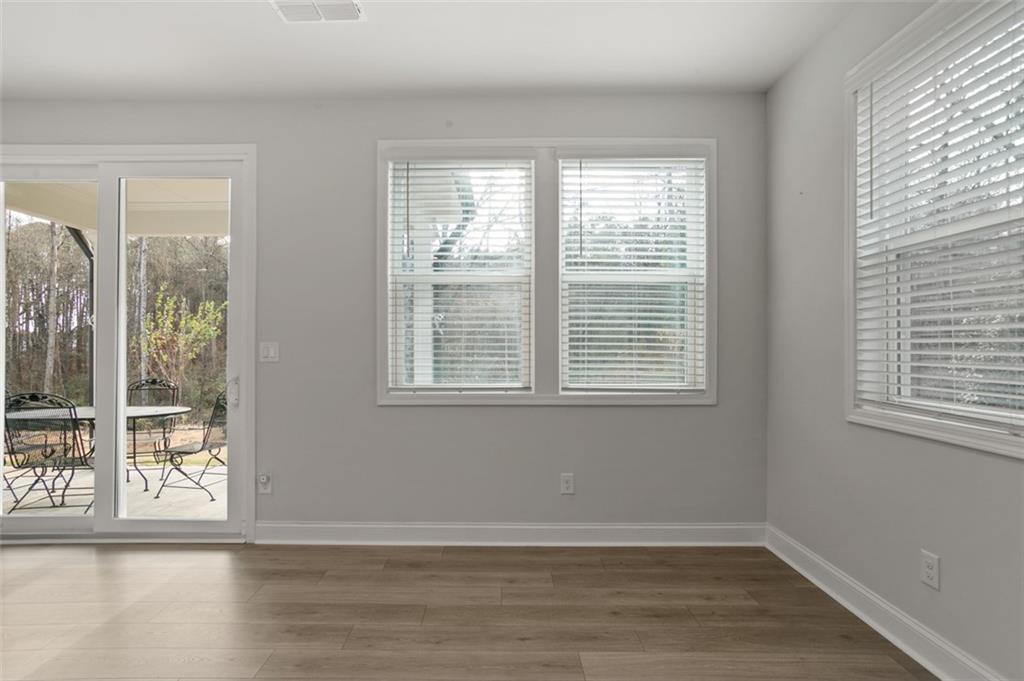 764 Clifftop Crossing Southwest Powder Springs, GA 30127 - Photo 13 of 38 a view of an empty room with wooden floor and a window