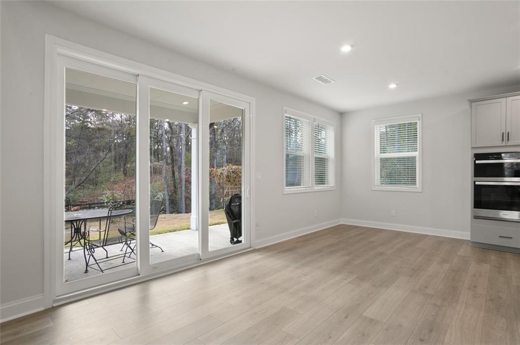 764 Clifftop Crossing Southwest Powder Springs, GA 30127 - Photo 14 of 38 a view of an empty room with a window and wooden floor