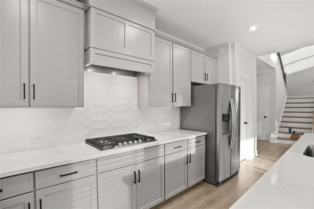 764 Clifftop Crossing Southwest Powder Springs, GA 30127 - Photo 17 of 38 a kitchen with cabinets and steel stainless steel appliances