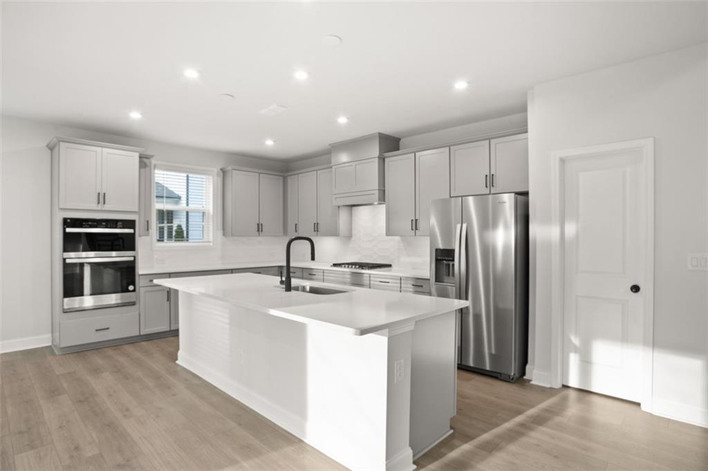 764 Clifftop Crossing Southwest Powder Springs, GA 30127 - Photo 18 of 38 a kitchen with stainless steel appliances granite countertop a refrigerator a sink and a stove