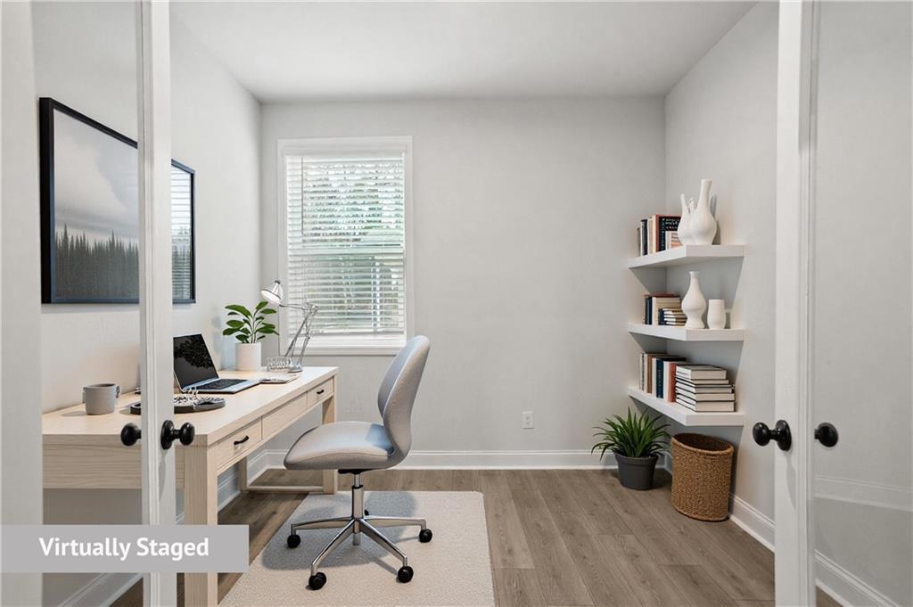764 Clifftop Crossing Southwest Powder Springs, GA 30127 - Photo 19 of 38 a view of a workspace with furniture and a potted plant
