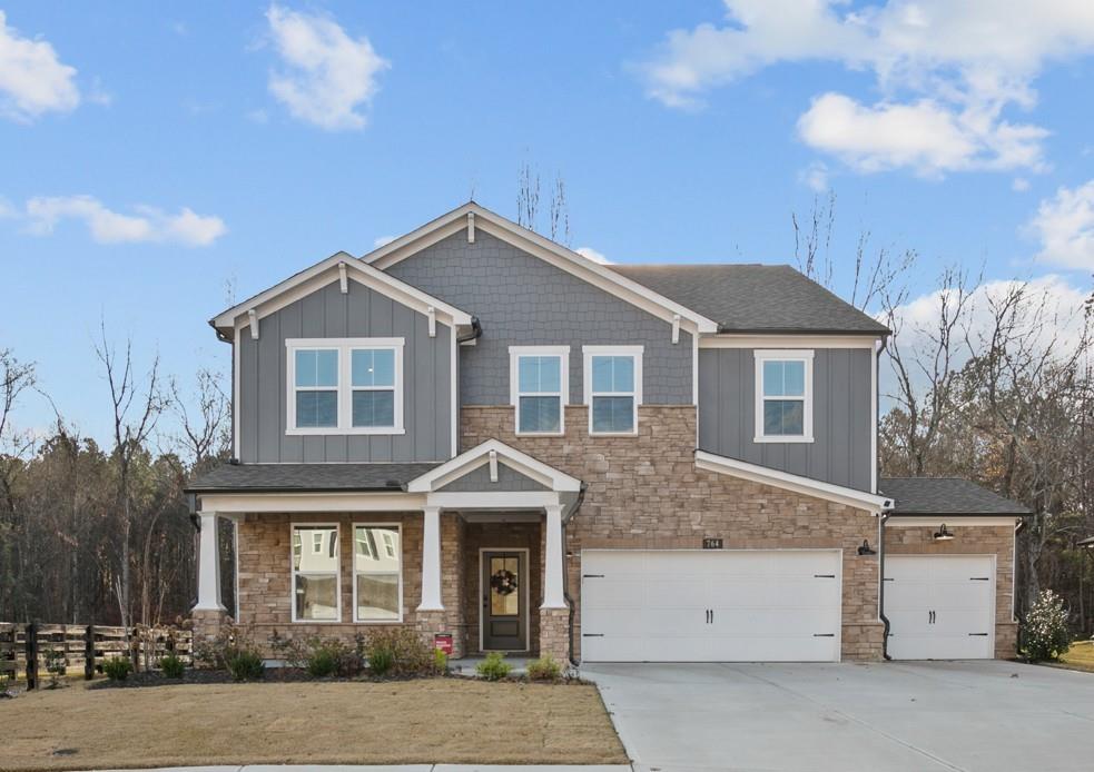 764 Clifftop Crossing Southwest Powder Springs, GA 30127 - Photo 2 of 38 a front view of a house with a yard