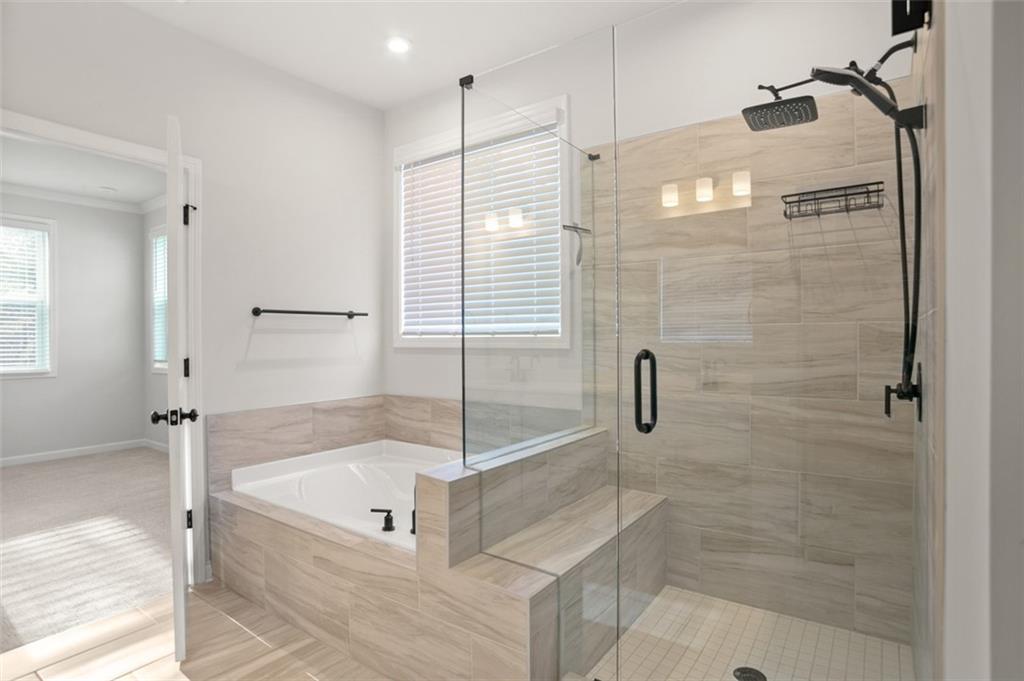 764 Clifftop Crossing Southwest Powder Springs, GA 30127 - Photo 28 of 38 a bathroom with a bathtub and a shower