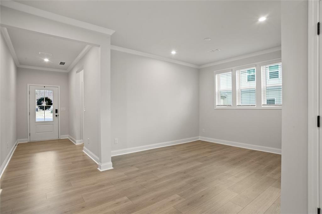 764 Clifftop Crossing Southwest Powder Springs, GA 30127 - Photo 5 of 38 wooden floor in an empty room with a window