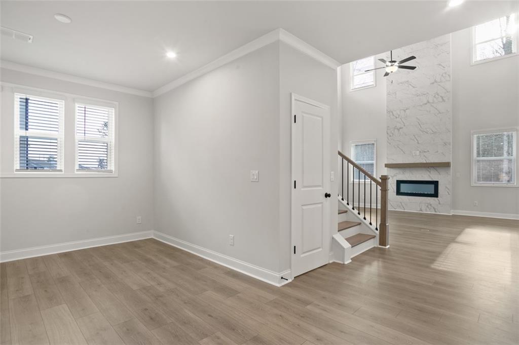 764 Clifftop Crossing Southwest Powder Springs, GA 30127 - Photo 6 of 38 an empty room with wooden floor and windows