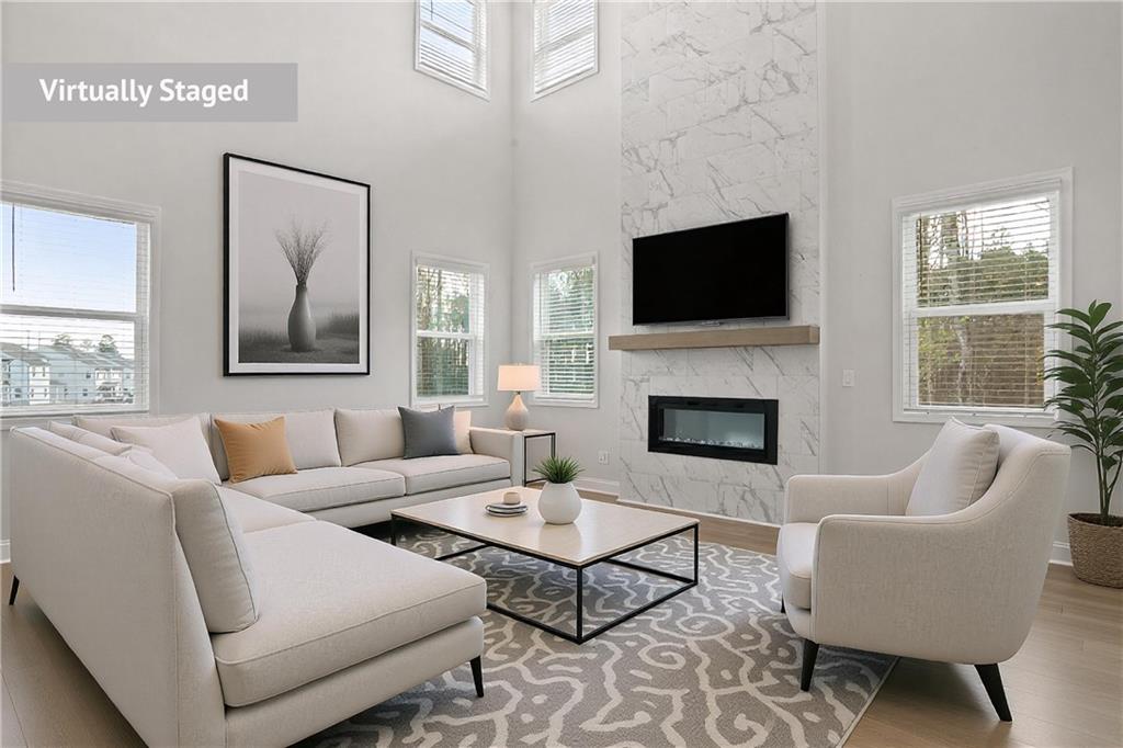 764 Clifftop Crossing Southwest Powder Springs, GA 30127 - Photo 7 of 38 a living room with furniture a flat screen tv and a fireplace