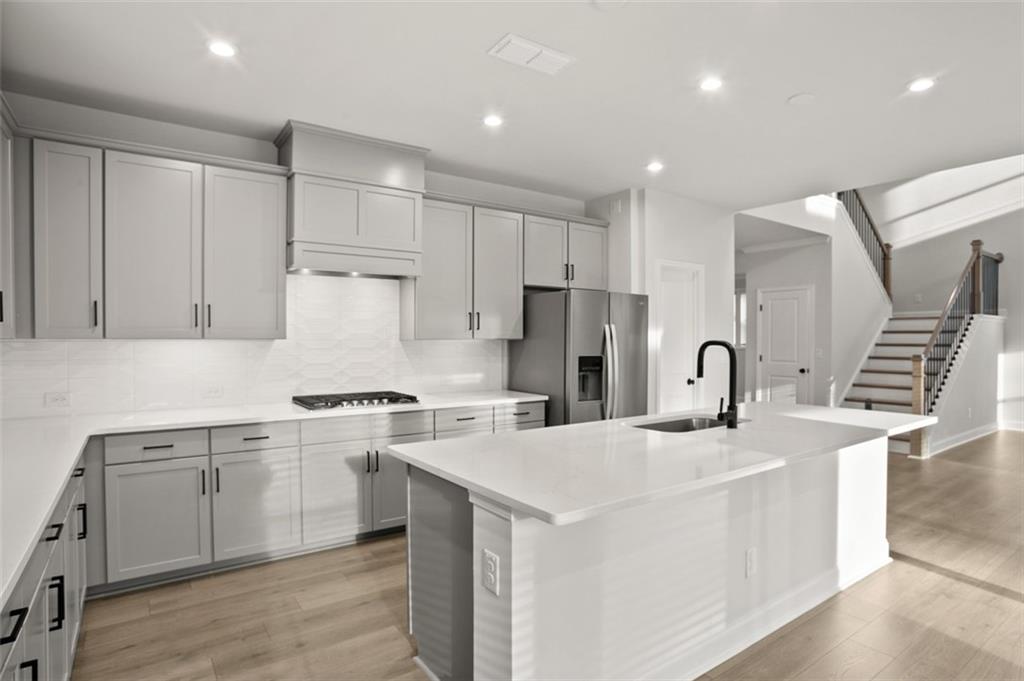 764 Clifftop Crossing Southwest Powder Springs, GA 30127 - Photo 10 of 38 a kitchen with stainless steel appliances granite countertop a sink stove and refrigerator