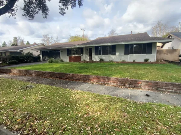 a front view of a house with a garden